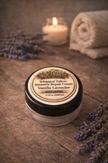 Sample container of Vanilla Lavender Intensive Repair Cream with lavender and candle in the background